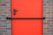 black steel Shed Security Bar, Garage and Garden Security on a red door and brick background